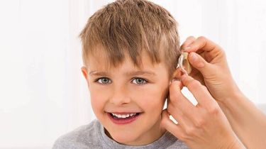 Young Boy Wearing A Hearing Aid